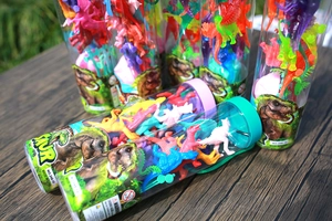 Detailed outdoor view of mini plastic dinosaur toy sets in colorful transparent barrels