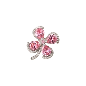 Close-up of pink pear-cut gemstone clover brooch with silver pavé diamond detailing