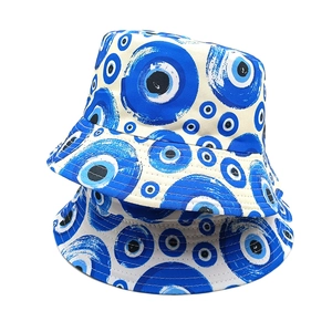 Blue and white bucket hats featuring classic Evil Eye patterns on a clean white background