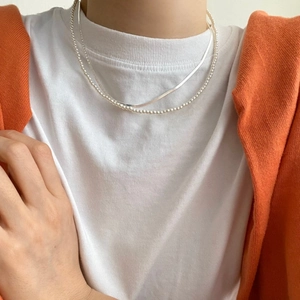 Close-up of layered 925 silver choker with fine bead chain and flat snake chain necklace