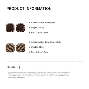 Detail view of retro square earrings with houndstooth fabric and sparkling rhinestone border