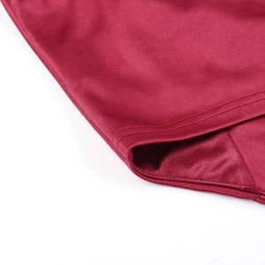 Detailed close-up showing the double-stitched seam on a burgundy satin camisole top