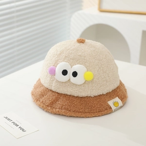 Close-up of soft lamb wool baby bucket hat with cute big eye patch and plush texture