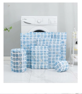Detail view of 6-piece mesh laundry bag set with blue heart patterns on marble surface