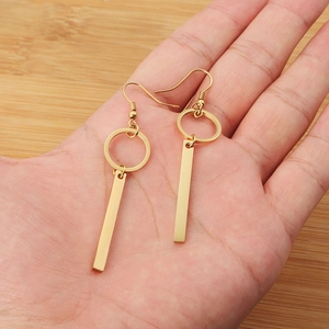 Minimalist geometric gold earrings with vertical rectangular bars and circular hoops