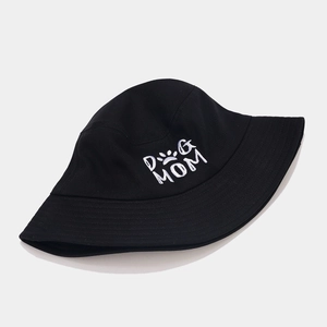 Black cotton bucket hat featuring white DOG MOM embroidery and heart paw print pattern