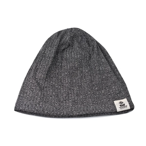 Close-up of grey knit beanie fabric texture and white Tunboy brand logo label