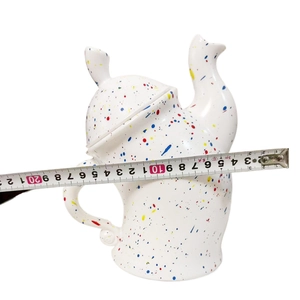 Detail showing white ceramic canister with colored spots measured at 17-18 cm width