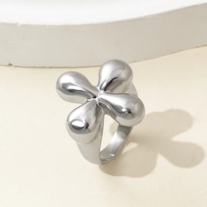 Polished silver titanium steel open ring with cross flower design on minimalist surface