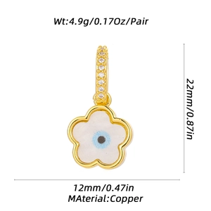 Detailed view of copper flower earrings with blue evil eye motif and size dimensions