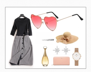 Flat lay of pink heart-shaped gradient sunglasses with summer fashion accessories