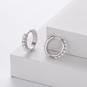 Close-up of S925 sterling silver hoop earrings featuring white pearls and zircon accents