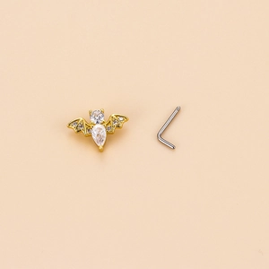 Golden bat-shaped nose stud with clear zircons and L-shaped stainless steel post