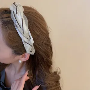 Braided mesh headband with crystal beads and white organza on elegant female model
