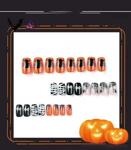 Detail view of Halloween press-on nails with spider, web, and mummy eye patterns