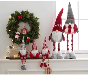 Close-up of assorted plush Christmas gnomes with knitted hats in red, grey and white