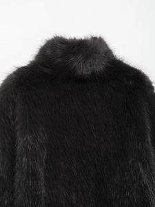 Detailed close-up of the stand-up collar and faux fur texture on the black short jacket