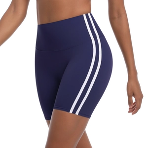 Detailed macro view of navy blue high-waist yoga shorts with side double white stripes