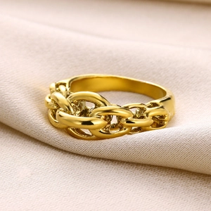 Detailed macro shot of the golden cuban link chain ring on a beige silk background