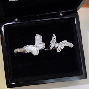 Macro detail of silver butterfly bangle with mother of pearl and cubic zirconia in a box