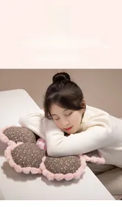 Floral plush cushion detail showing a model napping comfortably on soft fabric