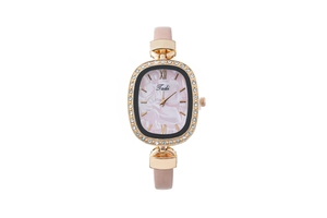 Detail of pink leather strap and rose gold oval watch case with sparkling crystal bezel