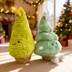 Plush Christmas tree dolls with stars and smiley faces in a festive interior setting