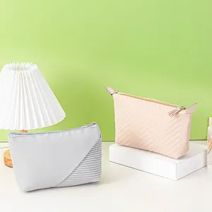 Portable dumpling makeup bags in grey striped and pink quilted faux leather