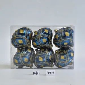 Detail of six dark blue Christmas ornaments with gold glitter mesh in a transparent box