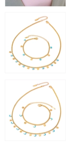 Detailed macro view of gold-plated stainless steel star and blue enamel moon charms