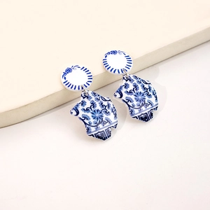 Macro detail of Chinese blue and white porcelain style earrings with floral pattern