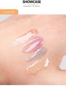 Macro shot of colorful glitter lip gloss swatches in orange, purple, blue, and gold