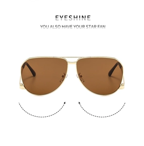 Close-up of golden metal frame aviator sunglasses with brown lenses and double bridge design