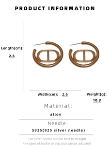 Detailed view of gold C-shaped earrings with CD letter logo and size dimensions