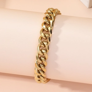 Classic gold Cuban link chain bracelet in stainless steel on a pink display stand