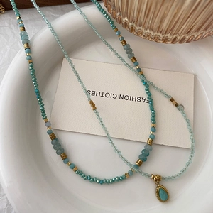 Natural amazonite beaded necklace with waterdrop pendant on a white decorative plate