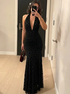 Elegant black polka dot halter maxi dress with deep V-neck and open back for formal events