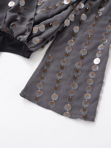 Detail shot of shimmering silver and bronze sequins on grey chiffon women's bodysuit
