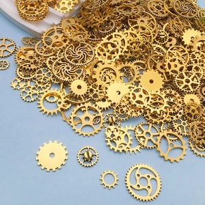 Close-up of mixed size golden metal steam punk gears for DIY jewelry making and crafts