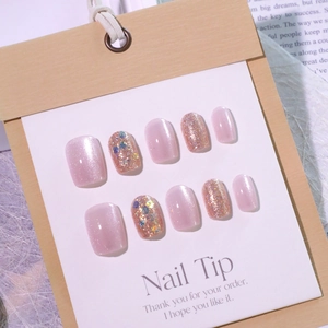 Sparkly pink cat eye press-on nails with glitter accents and a short square shape