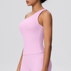 Detail of light pink one-shoulder yoga vest showing the elastic fabric and slim fit design