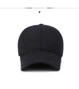 Front view showing thick twill texture and metal M logo on the winter baseball cap