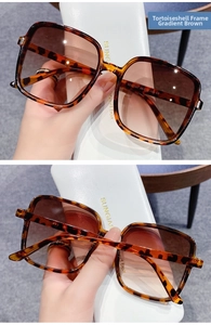 Detail of tortoise frame sunglasses with gradient tea lenses and inner arm model specs