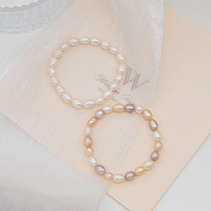 Minimalist freshwater pearl bracelets with white and multi-colored beads on soft fabric