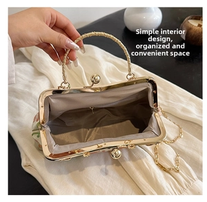 Interior detail of vintage embroidery bag showing the herringbone lining and metal clasp