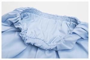Detailed close-up of light blue elastic waistband showing high-quality fabric stitching