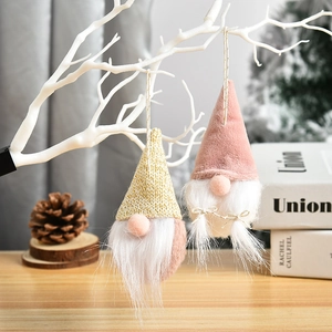 Cute pink and yellow faceless gnome ornaments hanging on a white decorative branch