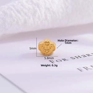 Macro shot of 5mm gold-finished Ruyi charm bead with matte finish for jewelry making