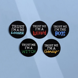 Set of 5 round metal badges with 'Trust Me' text phrases in assorted colors
