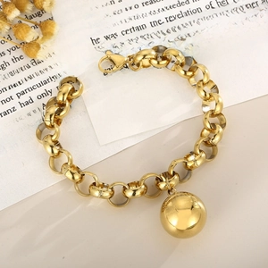 Macro detail of gold stainless steel pearl chain bracelet with spherical ball pendant